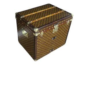 Front view of an antique piece to buy Louis Vuitton stenciled monogram steamer trunk from the 1920s, showing its leather trim and brass clasps.