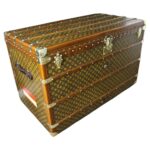 Front view of the Extra Large Louis Vuitton Steamer Trunk for sale, showing the 1920s monogram canvas, honey leather trim, and central brass lock.